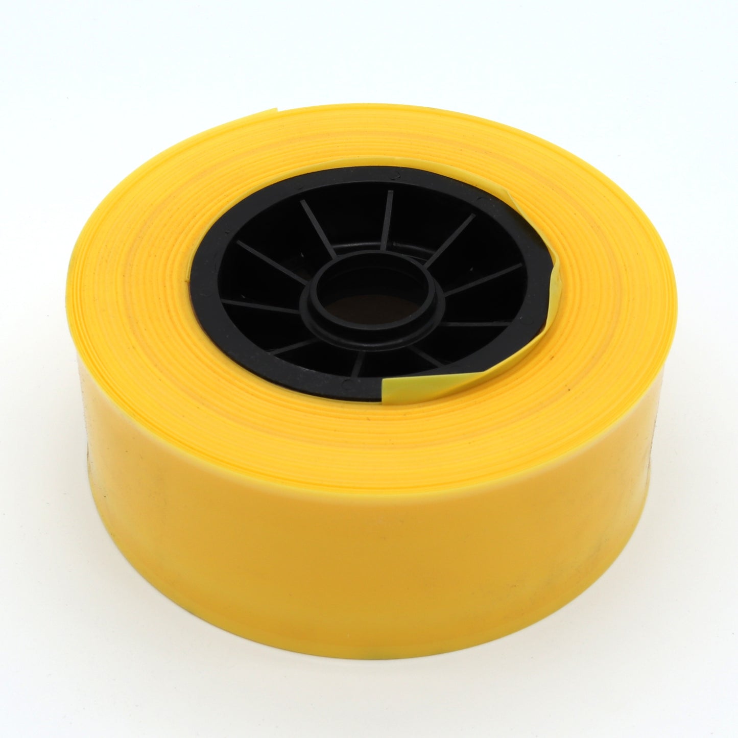 Yellow roll of tape on a white background